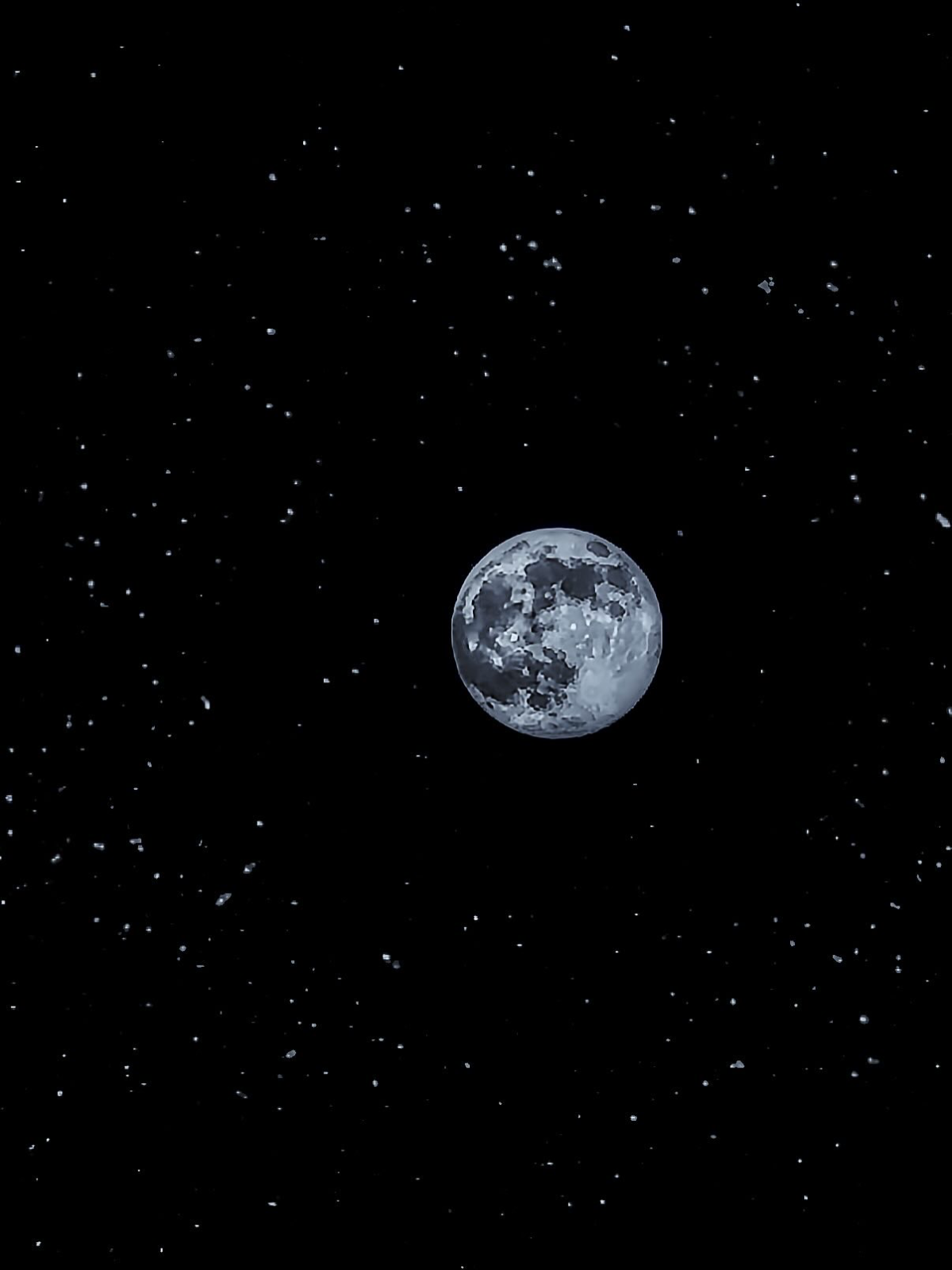 Detailed view of a bright full moon centered in a dark black sky surrounded by faint distant stars.