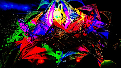 Intricate, glowing neon art installation featuring geometric string patterns, heart cutouts, and vibrant fluorescent colors against a dark background.