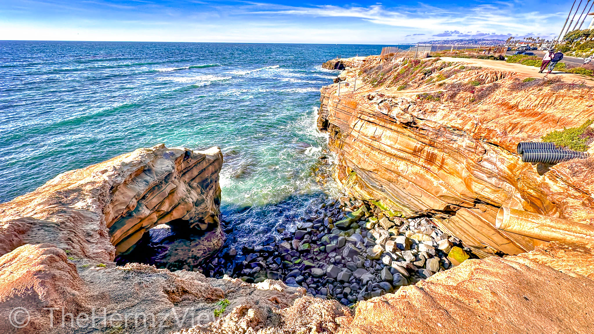 Pacific cliffs and ocean viewed through a coastal arch