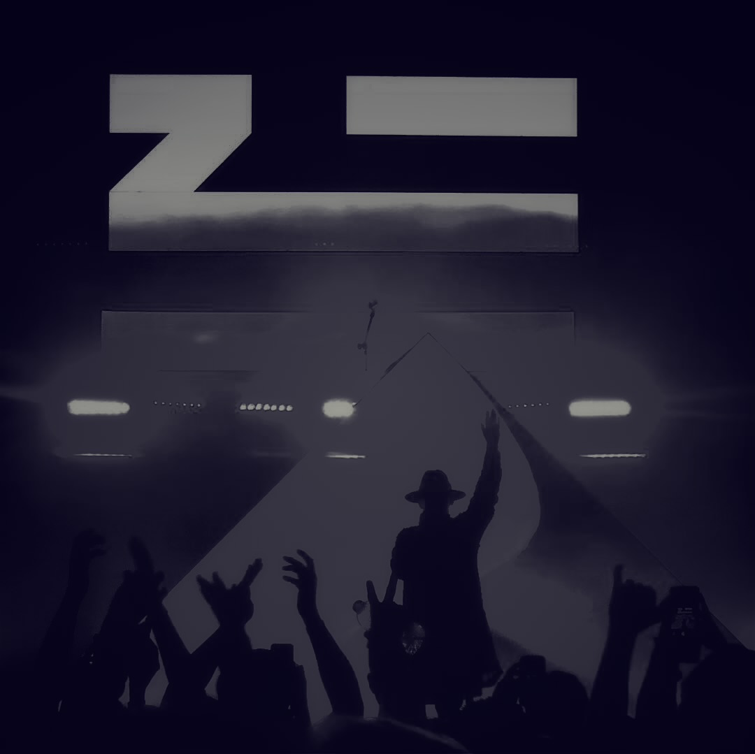 Silhouetted performer wearing a hat with one arm raised on a illuminated stage before a crowd with raised hands.